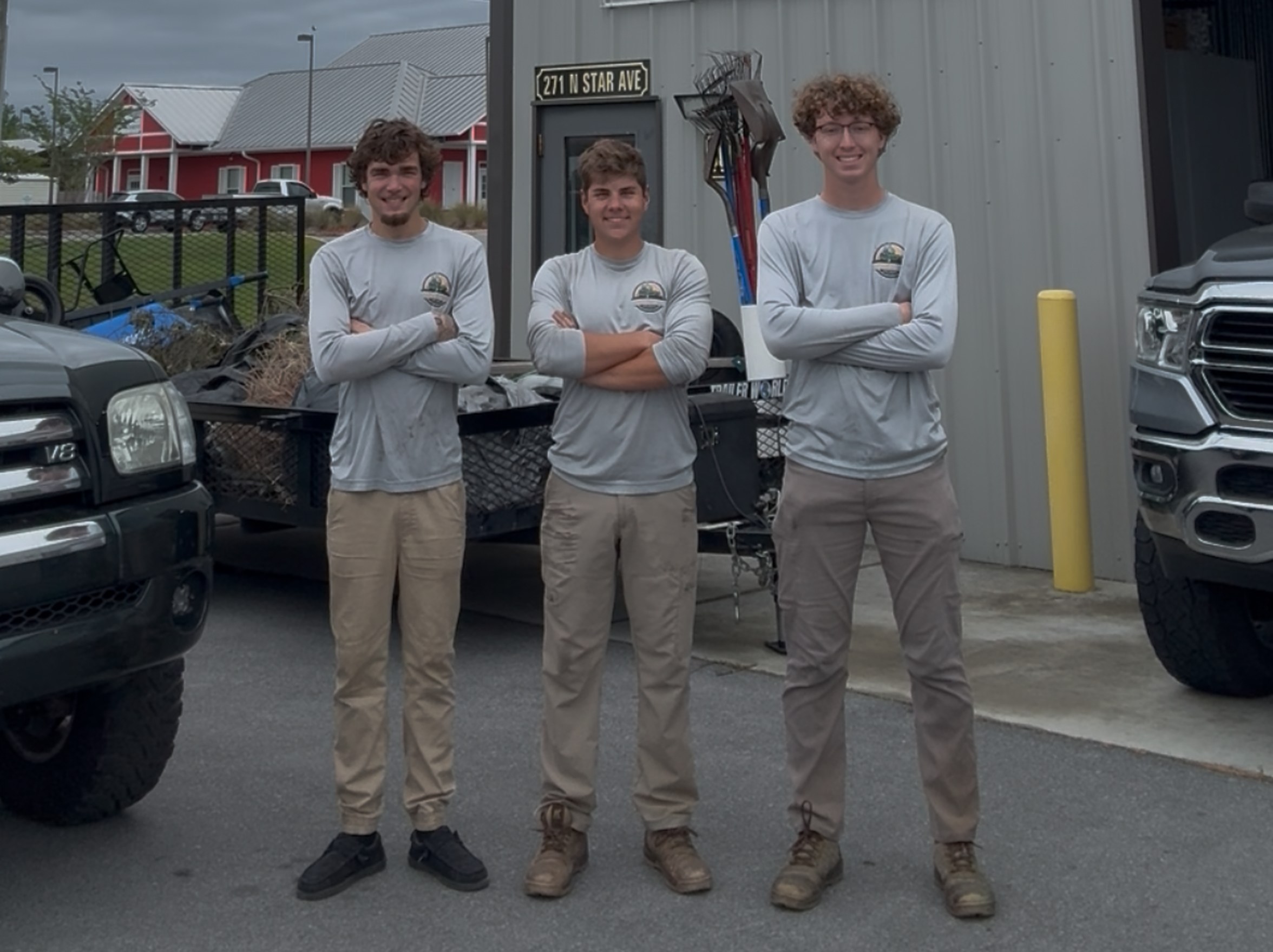 The Spiced Up Lawn Service team in branded uniforms at the shop